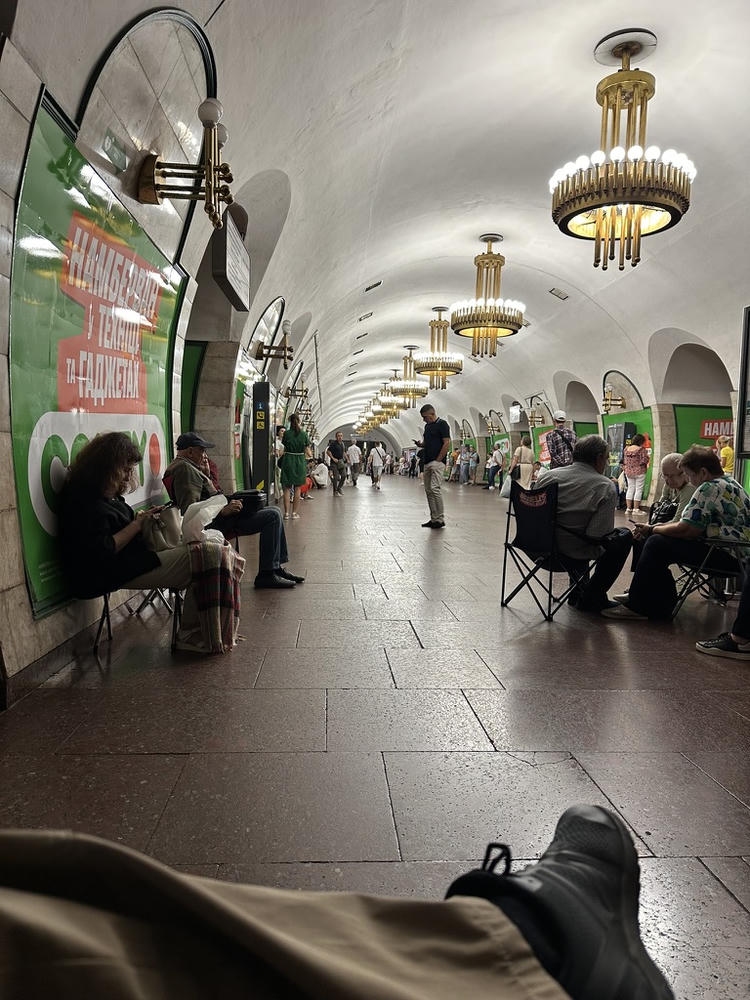 Perspective sitting in a camp chair in a Kyiv metro station during a mass Russian attack