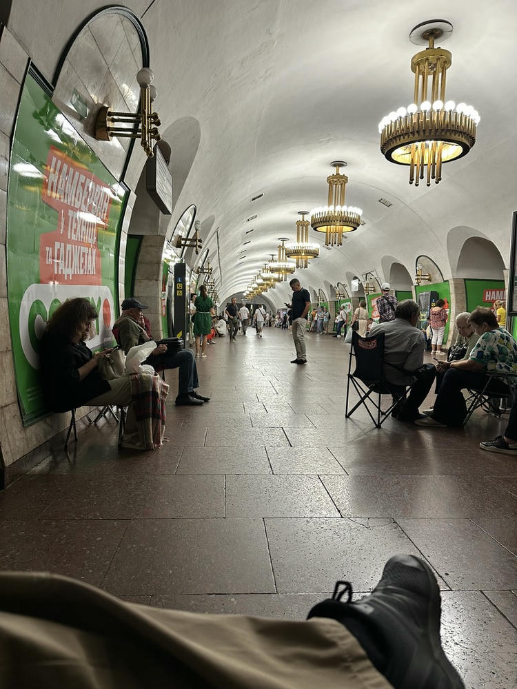 Perspective sitting in a camp chair in a Kyiv metro station during a mass Russian attack